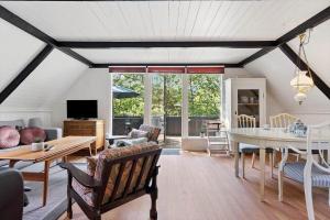 a living room with a couch and a table at 1105-ringkobing-Fyrrealle-20 in Nørby
