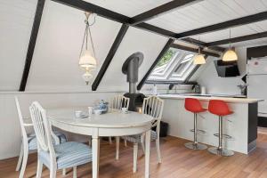 a kitchen and dining room with a table and chairs at 1105-ringkobing-Fyrrealle-20 in Nørby
