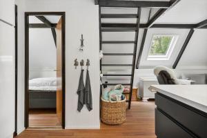 a room with a ladder and a bedroom with a bed at 1105-ringkobing-Fyrrealle-20 in Nørby