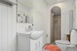 a white bathroom with a sink and a toilet at 1105-ringkobing-Fyrrealle-20 in Nørby +22 photos