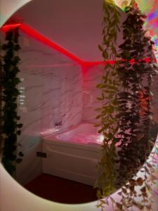 a bathroom with a white tub and a pink shower at Prenoćište SILVER LUX Srebrno Jezero in Veliko Gradište