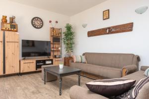 a living room with a couch and a tv at New Villa OLE, stone house, sea view, jacuzzi in Jesenice