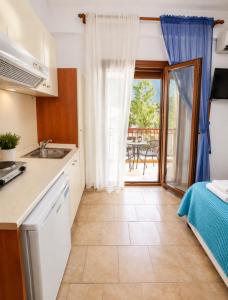 a kitchen with a sink and a bed in a room at Gallery in Ammouliani
