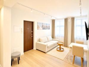 a living room with a couch and a table at Express Guest House in Klaipėda