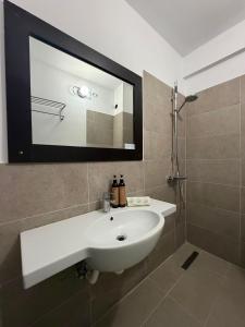 a bathroom with a white sink and a mirror at Hotel Amur in Corbu +29 photos