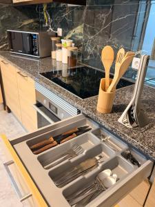 a kitchen with a sink with utensils in it at Moinho do vento in Nazaré