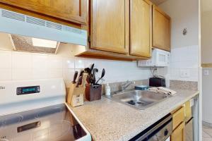 a kitchen with a sink and a counter top at Second-floor condo with 2 shared pools hot tub sauna in South Lake Tahoe