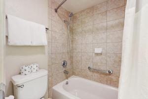 a bathroom with a white toilet and a shower at Second-floor condo with 2 shared pools hot tub sauna in South Lake Tahoe +32 photos