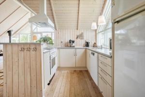 a kitchen with white appliances and a wooden ceiling at FY244-Assens-Osterbakken-3 in Assens +14 photos