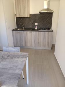 a kitchen with a sink and a counter top at Affittacamere La Casa Dei Nonni in Polizzi Generosa +23 photos
