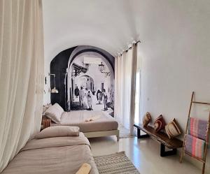 a bedroom with two beds and an archway at Dar El Monchar - Hammamet in Hammamet