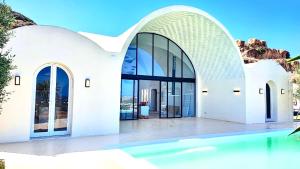 a large white building with a pool in front at Dar El Monchar - Hammamet in Hammamet +22 photos