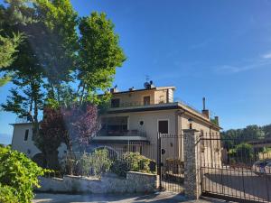 a white house with a fence in front of it at Casa Vacanze Masseria Tidei in Sant'Agata de' Goti