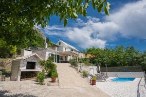 an exterior view of a house with a swimming pool at New Villa OLE, stone house, sea view, jacuzzi in Jesenice