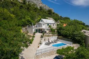 an aerial view of a house with a swimming pool at New Villa OLE, stone house, sea view, jacuzzi in Jesenice