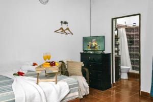 a bedroom with a bed with a table and a mirror at Ataco Cabin Views Breakfast and Coffee in Tacuba