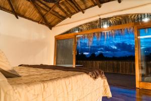 a bedroom with a bed and a window at Bali Andino Experience in Ciudad Lujan de Cuyo +103 photos