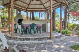 a patio with a table and chairs in a gazebo at Ataco Cabin Views Breakfast and Coffee in Tacuba
