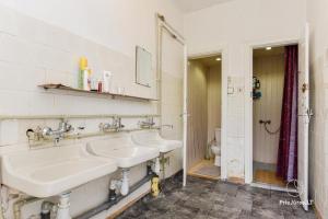 a bathroom with two sinks and a toilet at MiegOK777 in Palanga