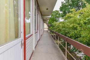 a walkway outside of a building with a window at MiegOK777 in Palanga
