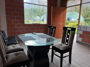 a glass table and two chairs in a room at Sky Domos Pachar in Pachar