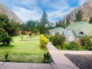 two domes in a garden with mountains in the background at Sky Domos Pachar in Pachar
