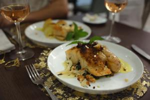 a plate of food on a table with glasses of wine at Private Douro- Quinta das Susandas in Mesão Frio