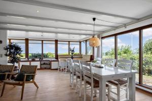 a kitchen and dining room with a white table and chairs at FY267-Faaborg-Horsehoved-37 in Faaborg