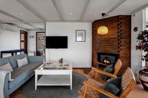 a living room with a couch and a fireplace at FY267-Faaborg-Horsehoved-37 in Faaborg