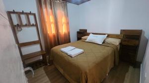 a bedroom with a bed with two towels on it at Hospedaje J & L in Uspallata