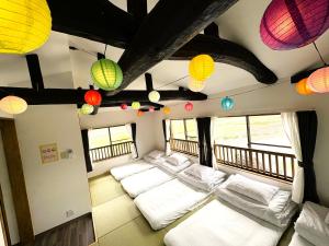 a room with white pillows and lamps on a train at とっくりhouse in Takashima