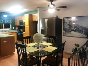 a dining room with a table and chairs and a kitchen at 4 Bedroom Vacation House With Pikes Peak view Pet-friendly in Aurora