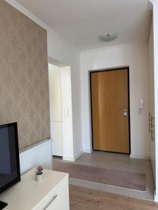 a living room with a door and a television at Mimi's Place in Gradačac