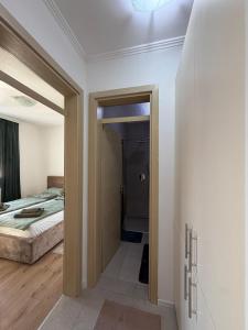 a bedroom with a door leading to a bed at Mimi's Place in Gradačac