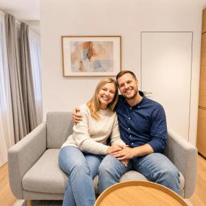 a man and a woman sitting on a couch at Superb Old Town Apartment in Klaipėda +5 photos