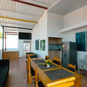 a kitchen and dining room with a wooden table and chairs at Casa Daguer Beach House in Cartagena de Indias