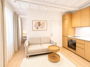 a living room with a couch and a table at Superb Old Town Apartment in Klaipėda