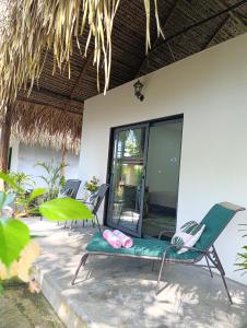 two chairs with flip flops sitting in front of a house at Chagres River Lodge in Santa Rosa