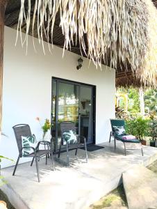 a patio with chairs and a table in front of a building at Chagres River Lodge in Santa Rosa