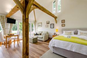 a bedroom with a large bed and a living room at 1 Bed in Piltdown oc-42814 in Newick