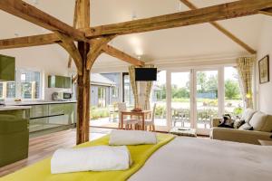 a kitchen and living room with a large bed at 1 Bed in Piltdown oc-42814 in Newick