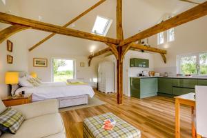 a large bedroom with a bed and a kitchen at 1 Bed in Piltdown oc-42814 in Newick +33 photos
