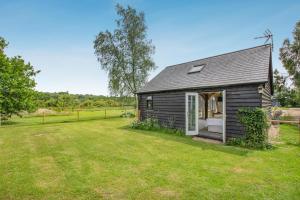 a small black shed with a large yard at 1 Bed in Piltdown oc-42814 in Newick