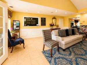 a living room with a couch and a chair at Jameson Inn - Perry in Perry
