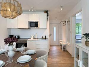 a kitchen and dining room with a table and chairs at Mira Premium Residences - Hinterzarten in Hinterzarten