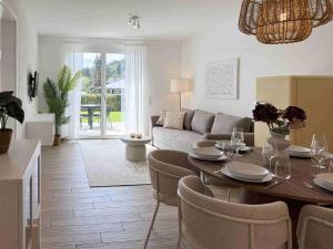 a living room with a table and a couch at Mira Premium Residences - Hinterzarten in Hinterzarten