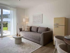 a living room with a couch and a table at Mira Premium Residences - Hinterzarten in Hinterzarten
