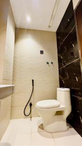 a bathroom with a toilet and a sink at Jinnah Mall Main Boulevard Jubilee Town in Lahore