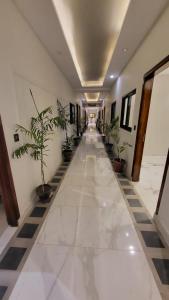 a hallway with potted plants in a building at Jinnah Mall Main Boulevard Jubilee Town in Lahore