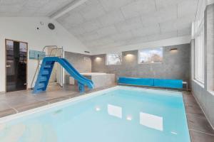 a indoor swimming pool with a slide in a house at 8876-Glesborg-Strandvejen-43 in Fjellerup Strand